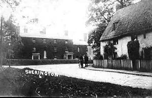 An old photo of an ivy-covered Manor House - the cottage on the right has not survived